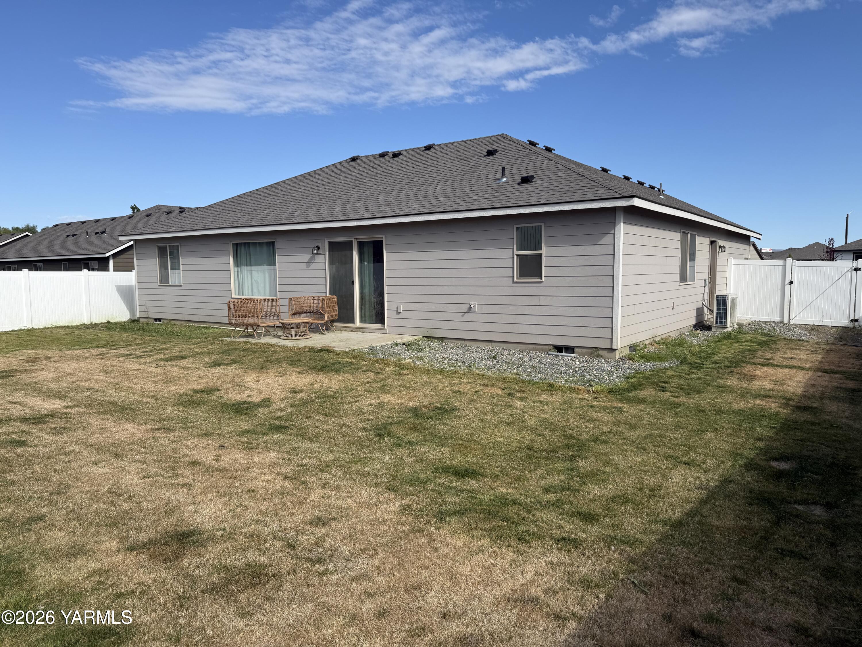 707 Grapevine Street Grandview, WA 98930 - Photo 14 of 14 a view of a house with a yard