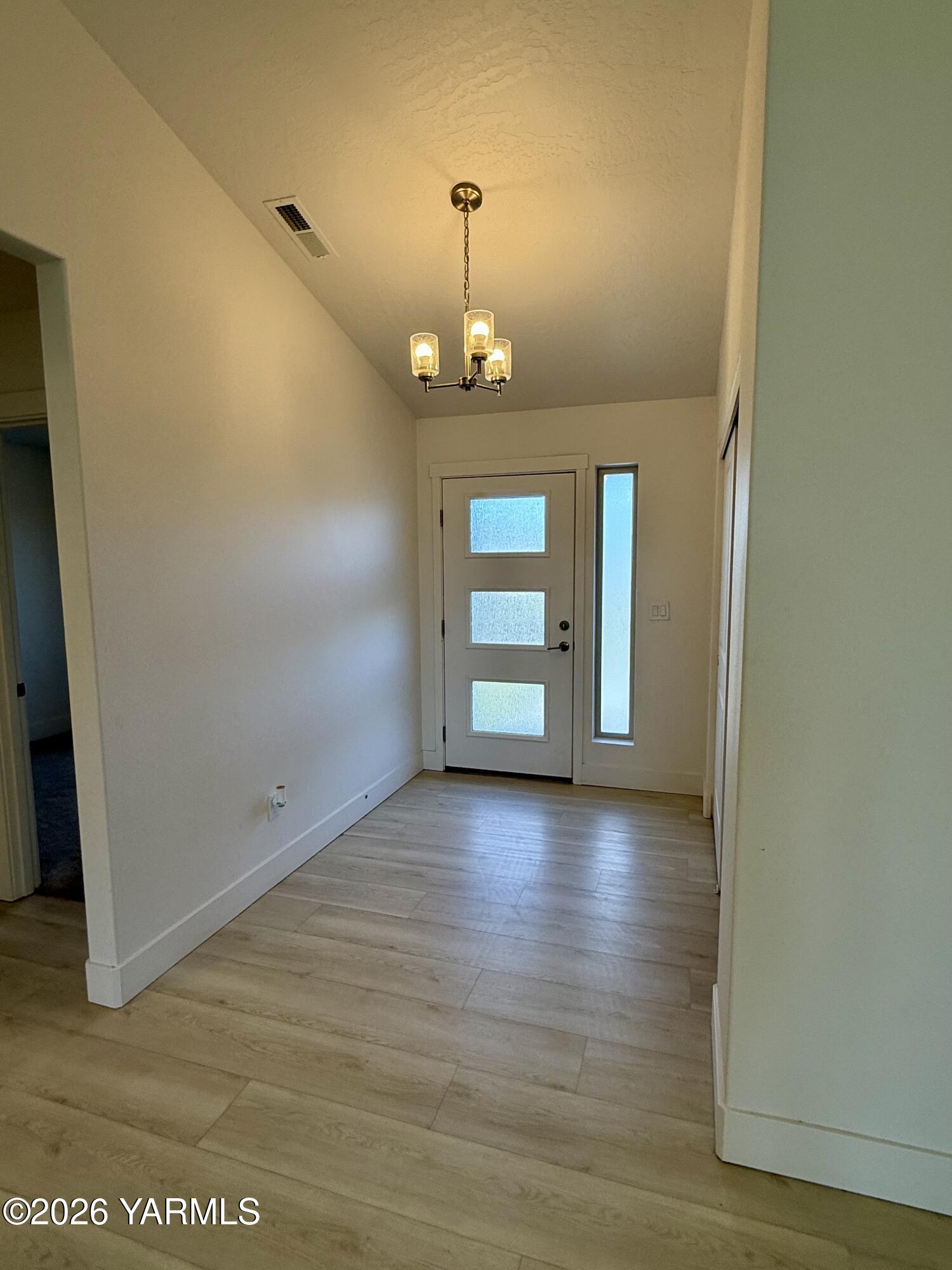 707 Grapevine Street Grandview, WA 98930 - Photo 8 of 14 wooden floor in an empty room with a window