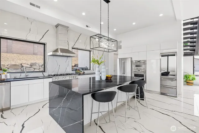 a kitchen with center island table and chairs