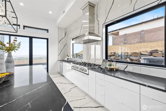 a large white kitchen with a large window