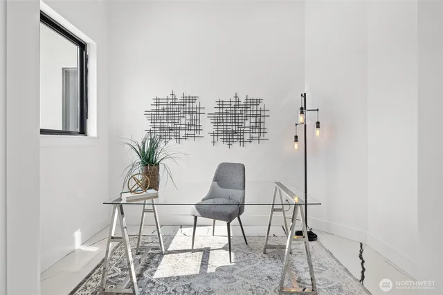 a work room with a chair and potted plant
