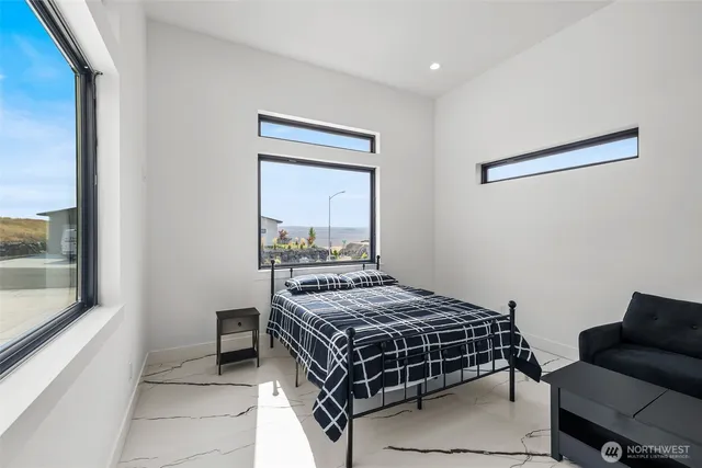 a bedroom with a bed and a window