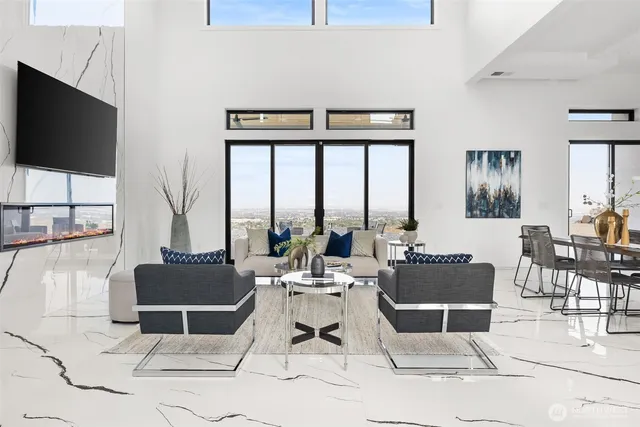 a living room with furniture a flat screen tv and a floor to ceiling window