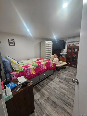 a bedroom with furniture and a wooden floor