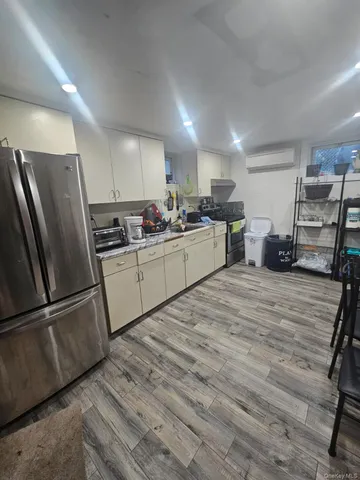 a kitchen with a refrigerator and a sink