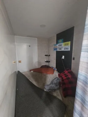 a bedroom with a bed and dresser