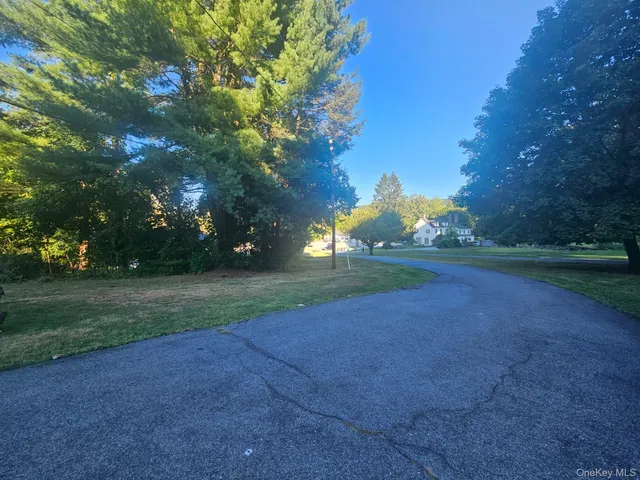 a view of dirt field with trees