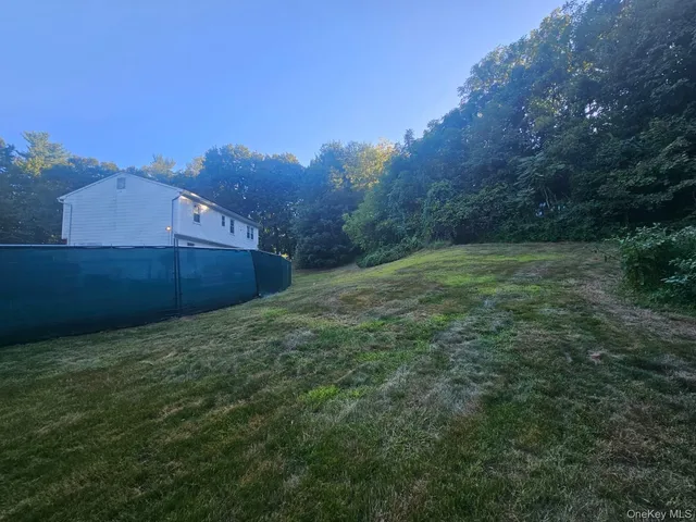 a view of a big yard with an trees