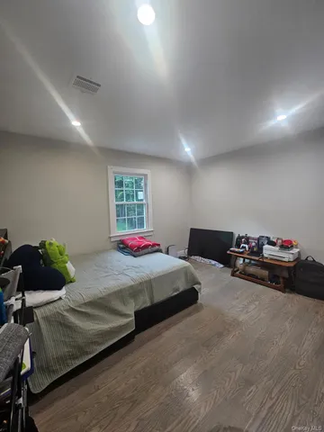 a bedroom with bed and a chandelier