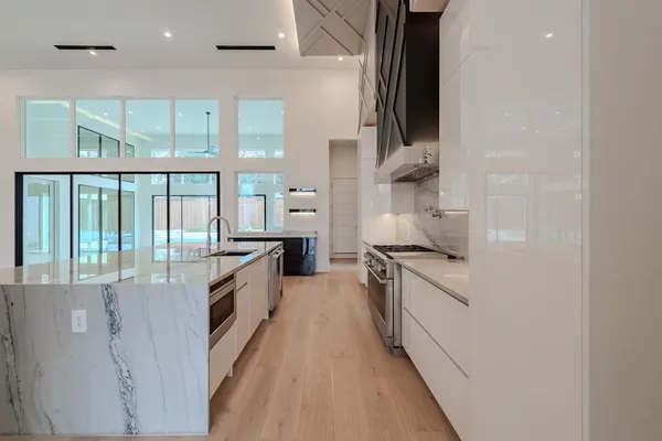 a kitchen with stainless steel appliances granite countertop a stove and a sink