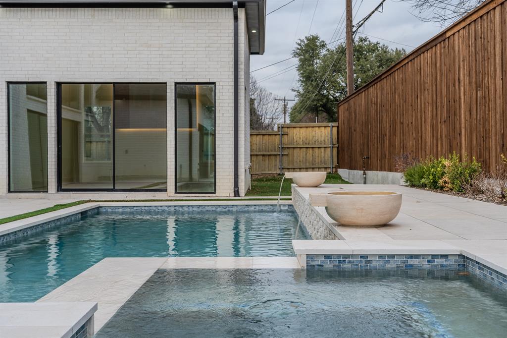 11314 Hillcrest Road Dallas, TX 75230 - Photo 2 of 40 a view of a swimming pool with a chair