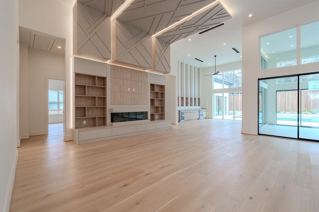11314 Hillcrest Road Dallas, TX 75230 - Photo 21 of 40 a view of a big room with wooden floor and windows