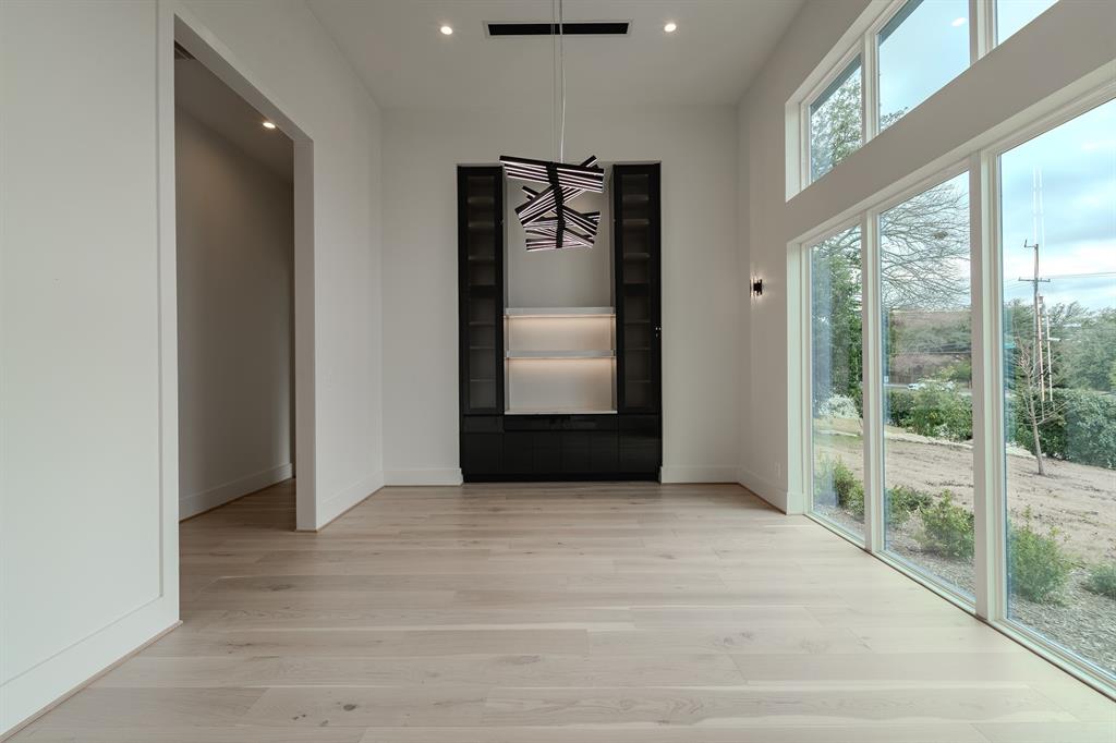 11314 Hillcrest Road Dallas, TX 75230 - Photo 28 of 40 a view of a hallway with wooden floor and door