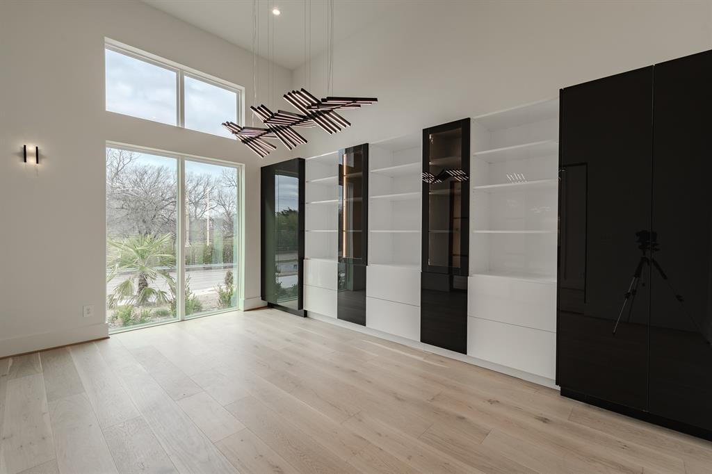 11314 Hillcrest Road Dallas, TX 75230 - Photo 29 of 40 a view of empty room with wooden floor and fan