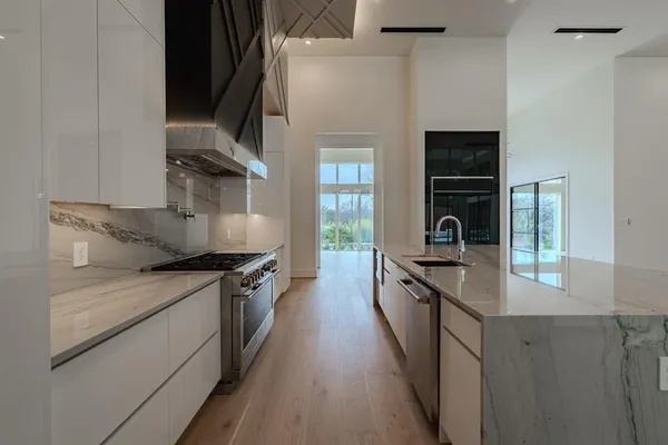 a kitchen with granite countertop a stove and a sink