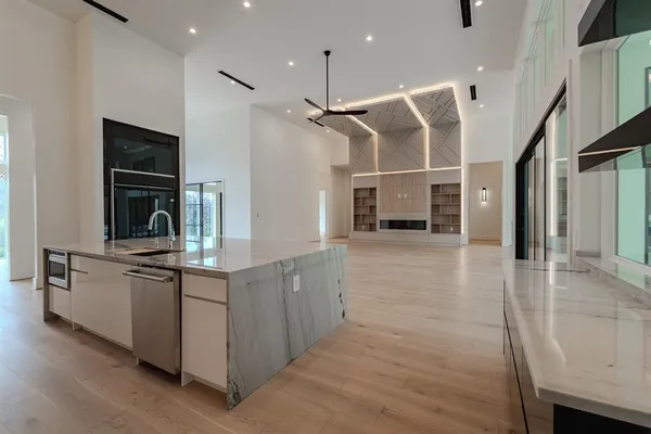 a kitchen with stainless steel appliances granite countertop a sink and refrigerator