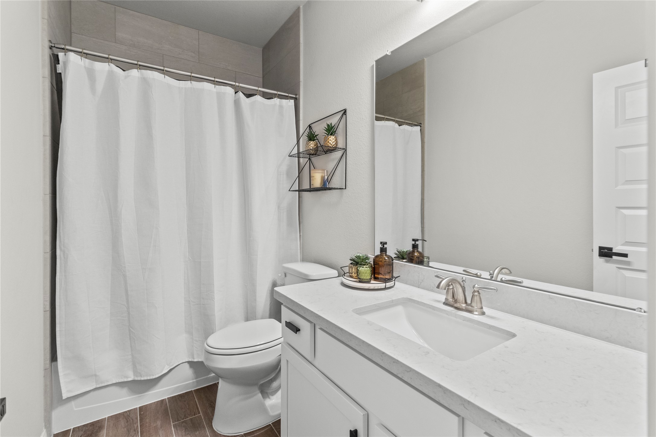 2811 Bisbee Road League City, TX 77573 - Photo 16 of 28 a bathroom with a granite countertop sink toilet and a mirror