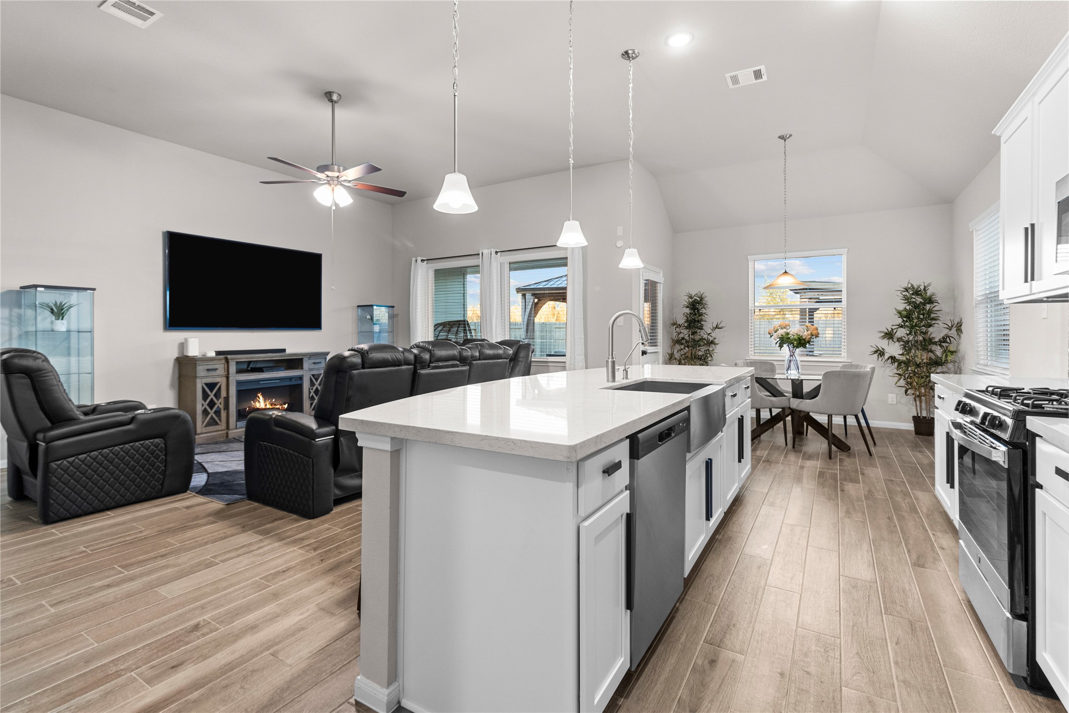 2811 Bisbee Road League City, TX 77573 - Photo 2 of 28 a large living room with stainless steel appliances granite countertop a stove a sink dishwasher a dining table and chairs with wooden floor