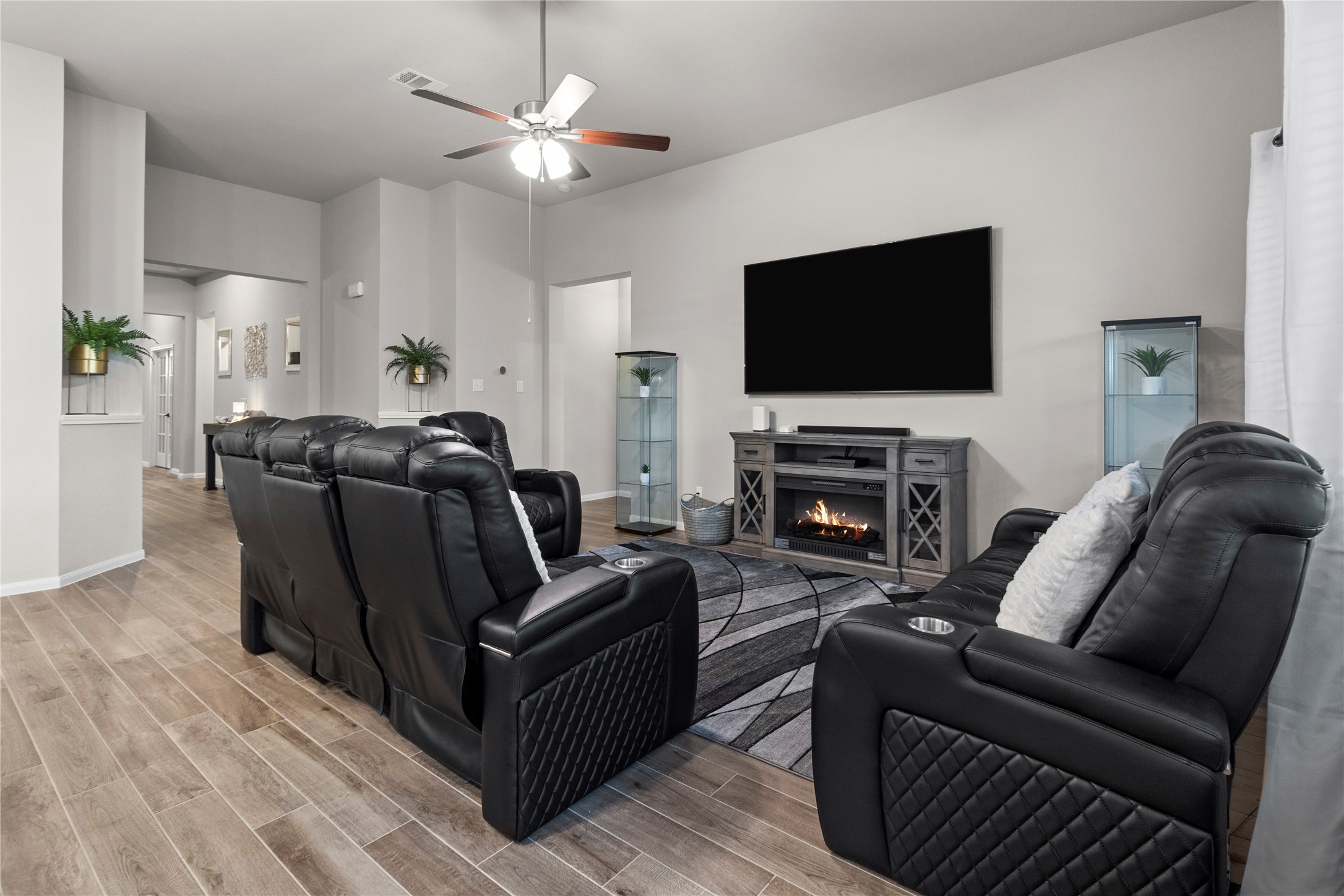 2811 Bisbee Road League City, TX 77573 - Photo 4 of 28 a living room with furniture a flat screen tv and a fireplace