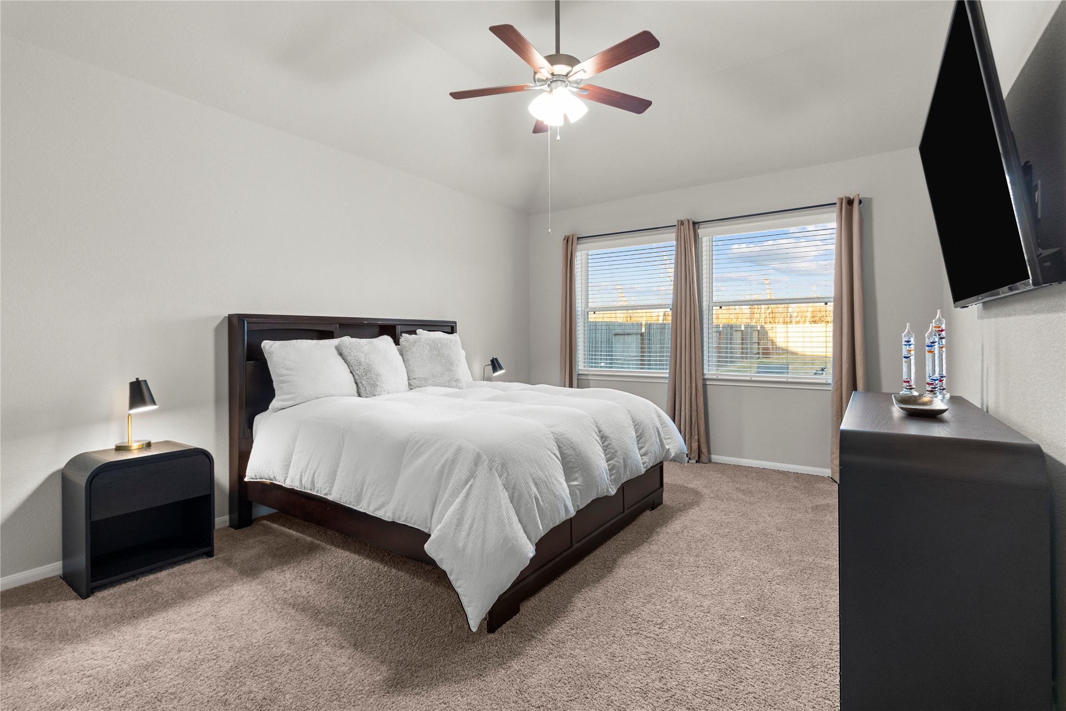 2811 Bisbee Road League City, TX 77573 - Photo 10 of 28 a bedroom with a bed and a flat tv screen on a dresser