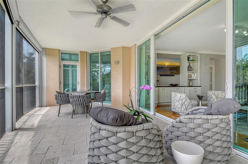 401 North Point Road, Unit 304 Osprey, FL 34229 - Photo 16 of 95 a living room with furniture and a floor to ceiling window