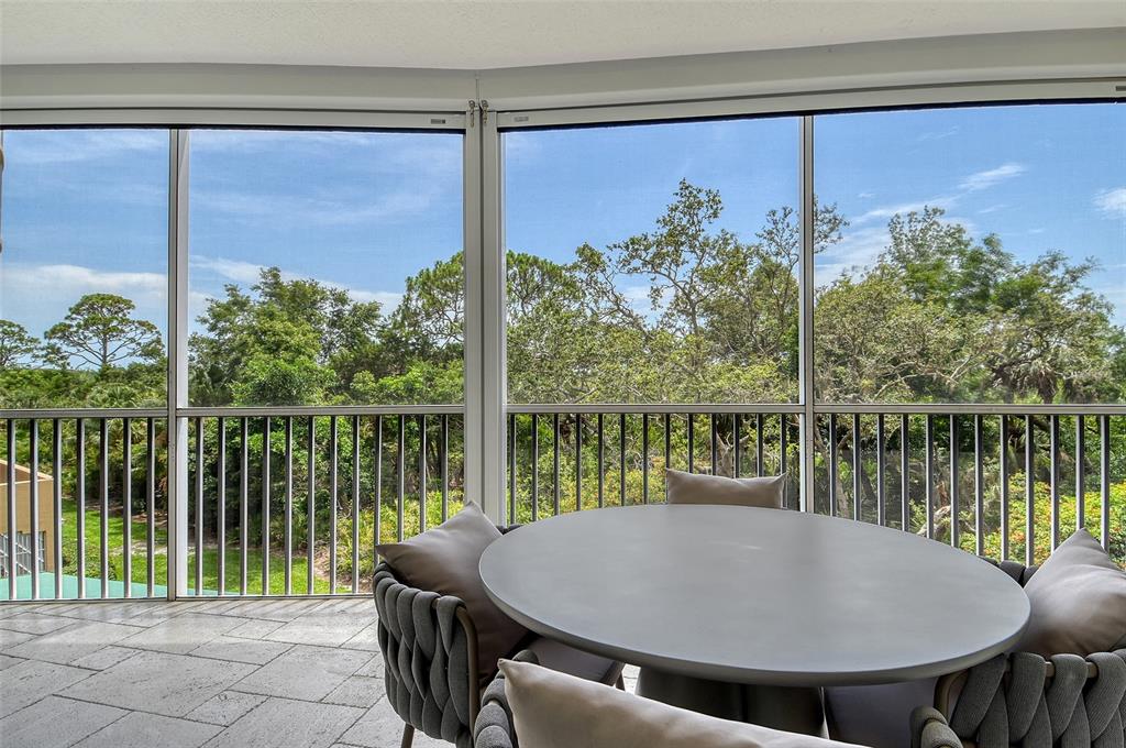401 North Point Road, Unit 304 Osprey, FL 34229 - Photo 17 of 95 a view of a balcony with lake view and a potted plant