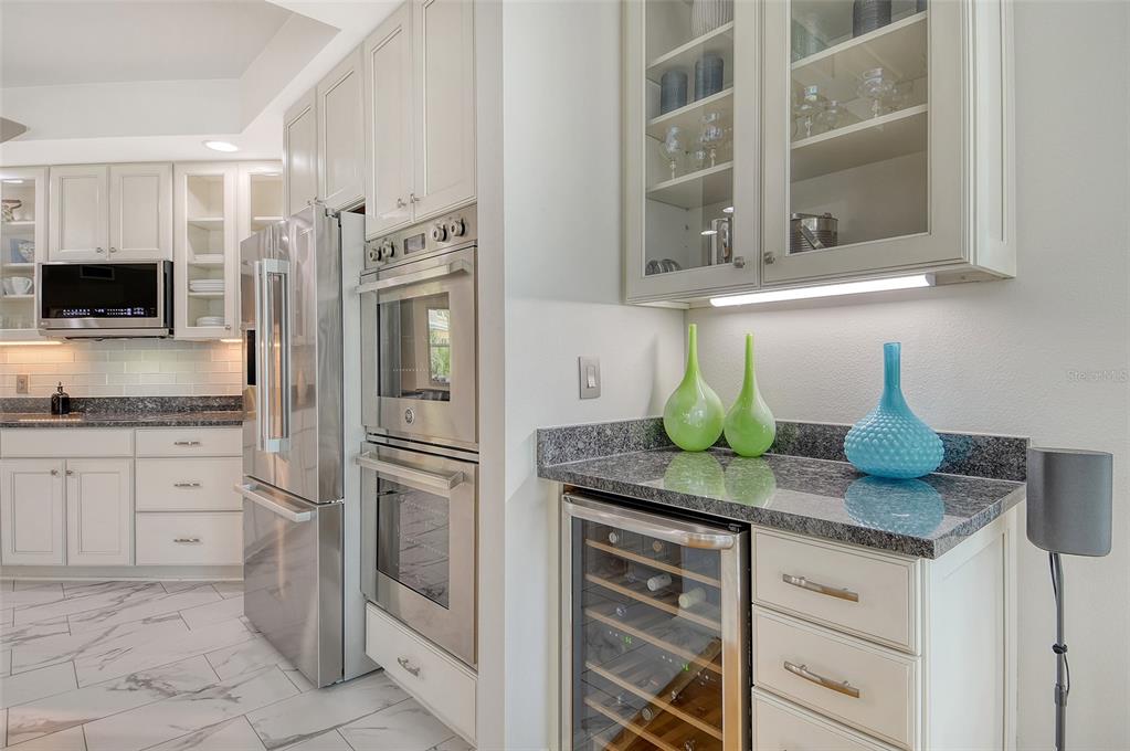 401 North Point Road, Unit 304 Osprey, FL 34229 - Photo 29 of 95 a kitchen with stainless steel appliances granite countertop a refrigerator and a stove