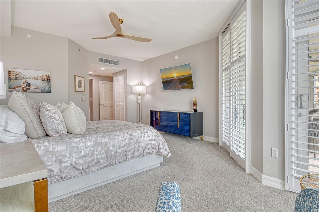 401 North Point Road, Unit 304 Osprey, FL 34229 - Photo 36 of 95 a bedroom with a bed and a chandelier