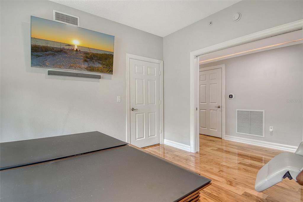 401 North Point Road, Unit 304 Osprey, FL 34229 - Photo 41 of 95 a view of a room with wooden floor and door