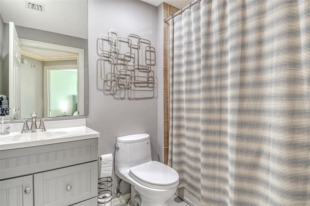 401 North Point Road, Unit 304 Osprey, FL 34229 - Photo 42 of 95 a bathroom with a toilet a sink and a shower curtain
