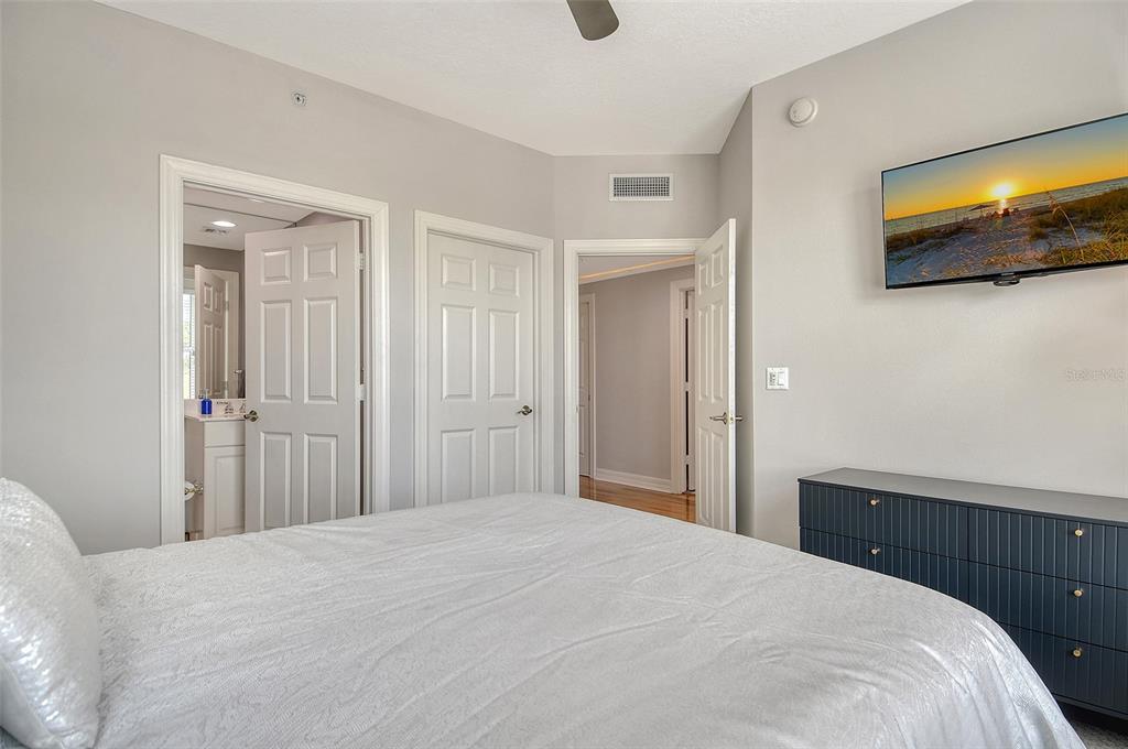 401 North Point Road, Unit 304 Osprey, FL 34229 - Photo 46 of 95 a bedroom with a bed and flat screen tv