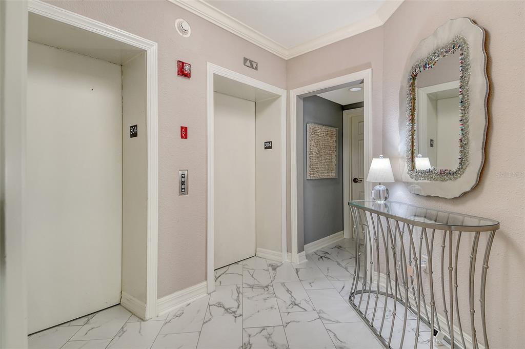 401 North Point Road, Unit 304 Osprey, FL 34229 - Photo 6 of 95 a view of a hallway with wooden floor and windows