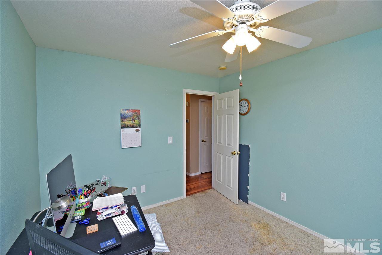 80 Calistoga Court Reno, NV 89508 - Photo 19 of 39 a bedroom with a bed and a chandelier