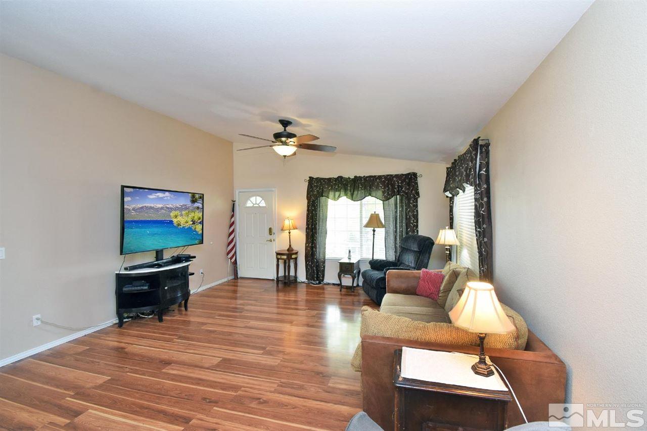 80 Calistoga Court Reno, NV 89508 - Photo 6 of 39 a living room with furniture and a chandelier