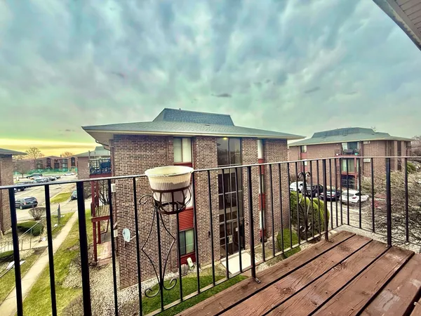 a view of a balcony with wooden floor