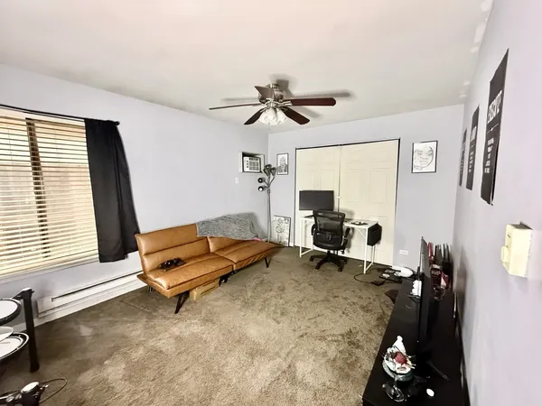 a living room with furniture gym equipment and a window