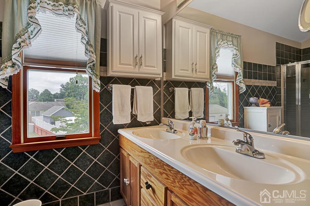 210 Oak Drive Middlesex, NJ 08846 - Photo 19 of 27 a bathroom with a sink and a mirror
