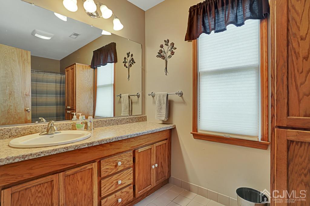 210 Oak Drive Middlesex, NJ 08846 - Photo 22 of 27 a bathroom with a sink double vanity and a shower