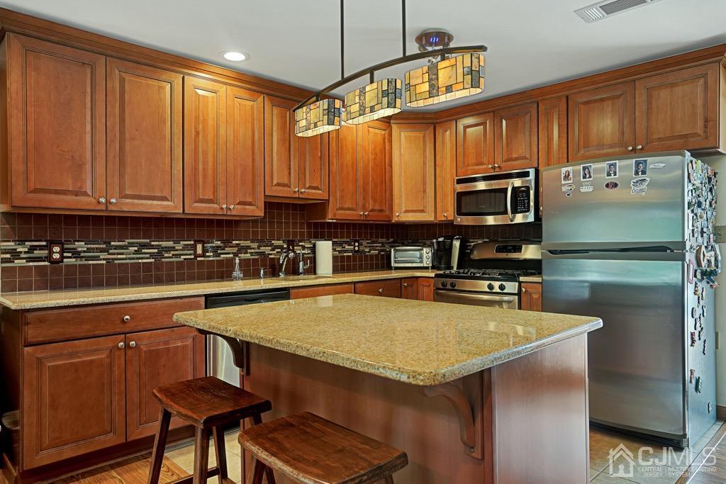 210 Oak Drive Middlesex, NJ 08846 - Photo 7 of 27 a kitchen with stainless steel appliances a stove a sink cabinets and a refrigerator