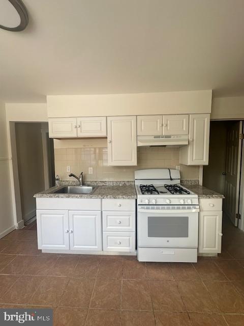 1082 Trent Road Camden, NJ 08104 - Photo 5 of 9 a kitchen with a stove top oven and cabinets
