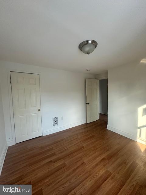 1082 Trent Road Camden, NJ 08104 - Photo 8 of 9 a view of an empty room with wooden floor and a window