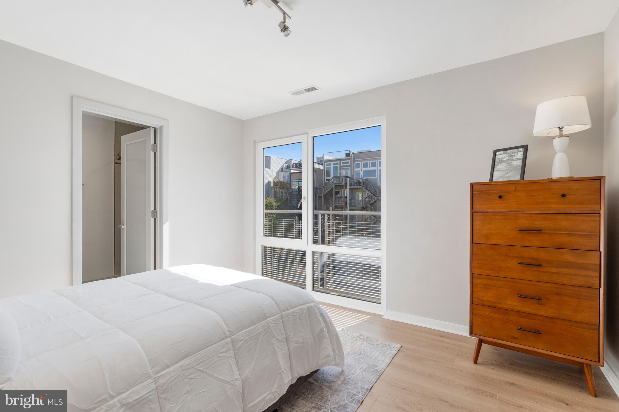 1466 Harvard Street Northwest, Unit A2 Washington, DC 20009 - Photo 20 of 31 a bedroom with a bed and a mirror