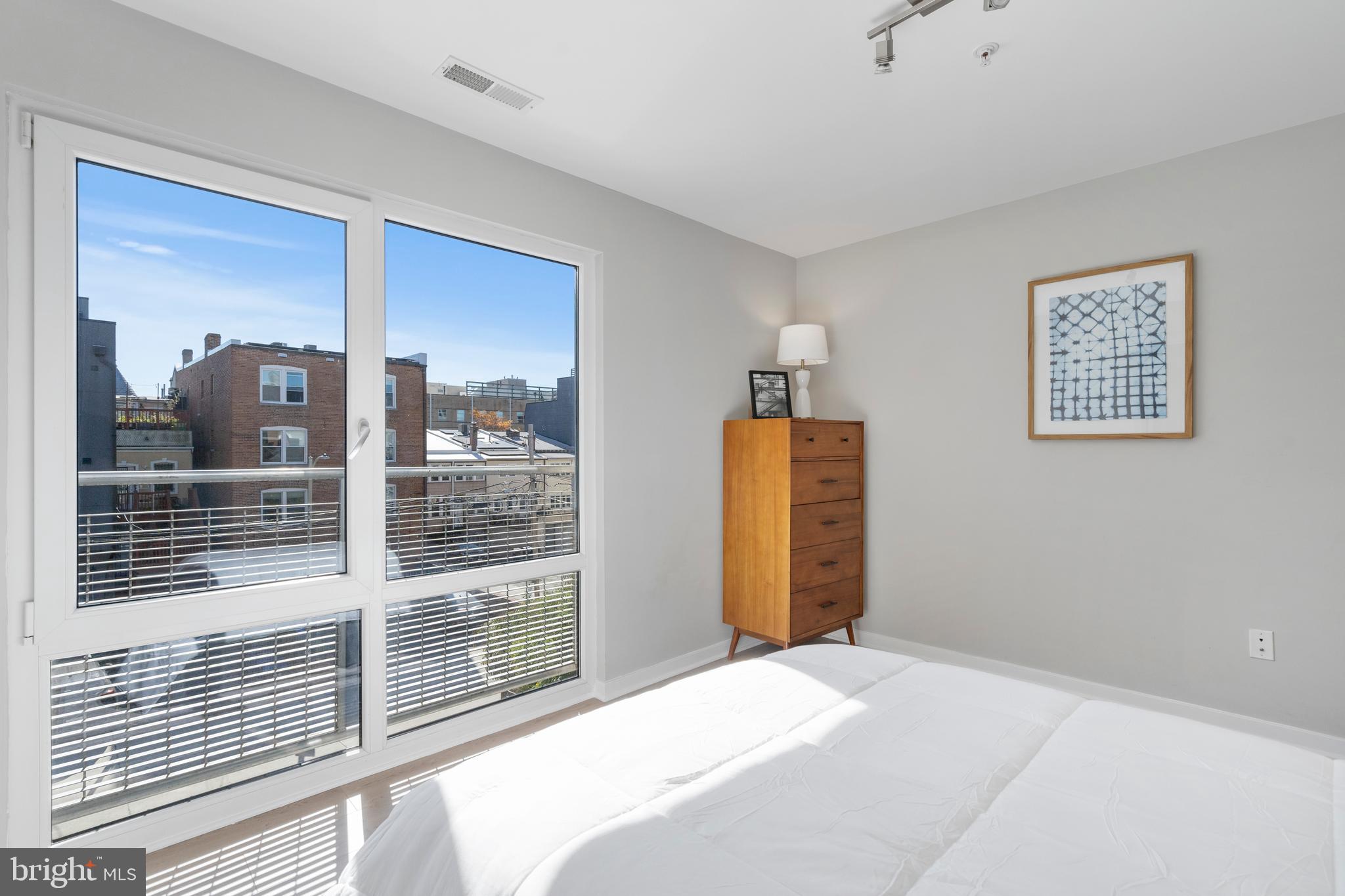 1466 Harvard Street Northwest, Unit A2 Washington, DC 20009 - Photo 22 of 31 a bedroom with a bed and a large window