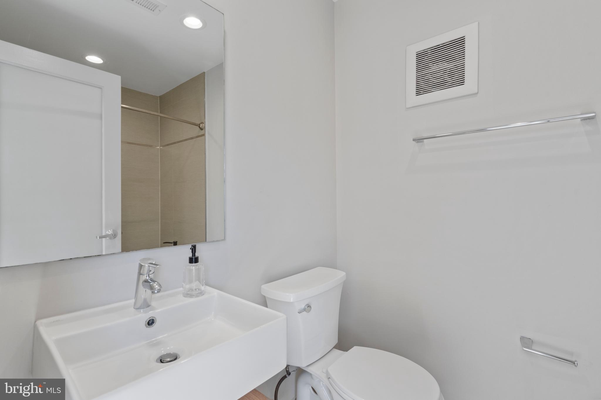 1466 Harvard Street Northwest, Unit A2 Washington, DC 20009 - Photo 23 of 31 a bathroom with a toilet sink and mirror