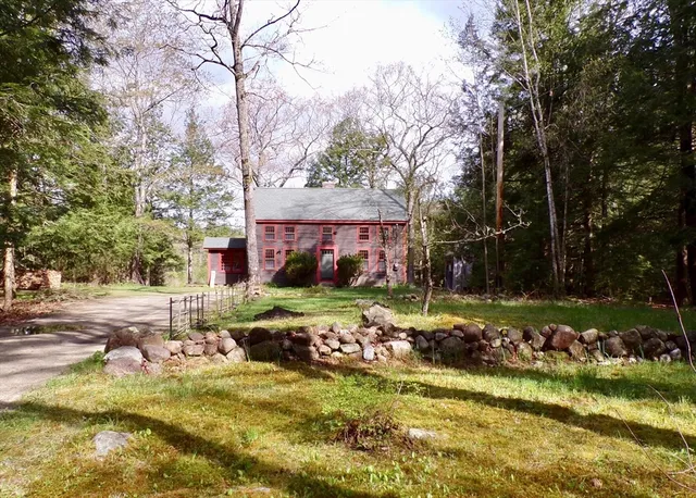 a view of swimming pool with a yard and large trees