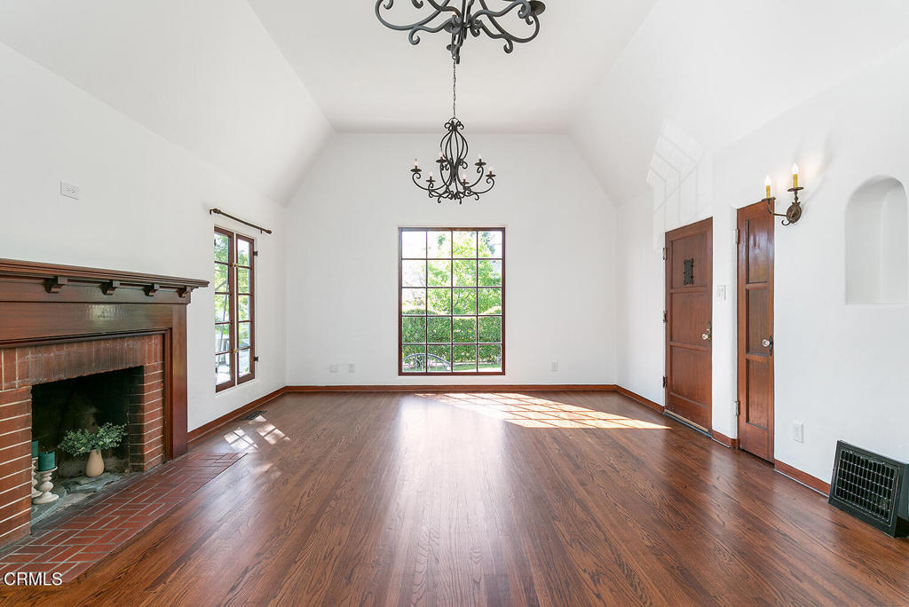5240 Ellenwood Place Los Angeles, CA 90041 - Photo 5 of 25 a view of an empty room with wooden floor fireplace and a window