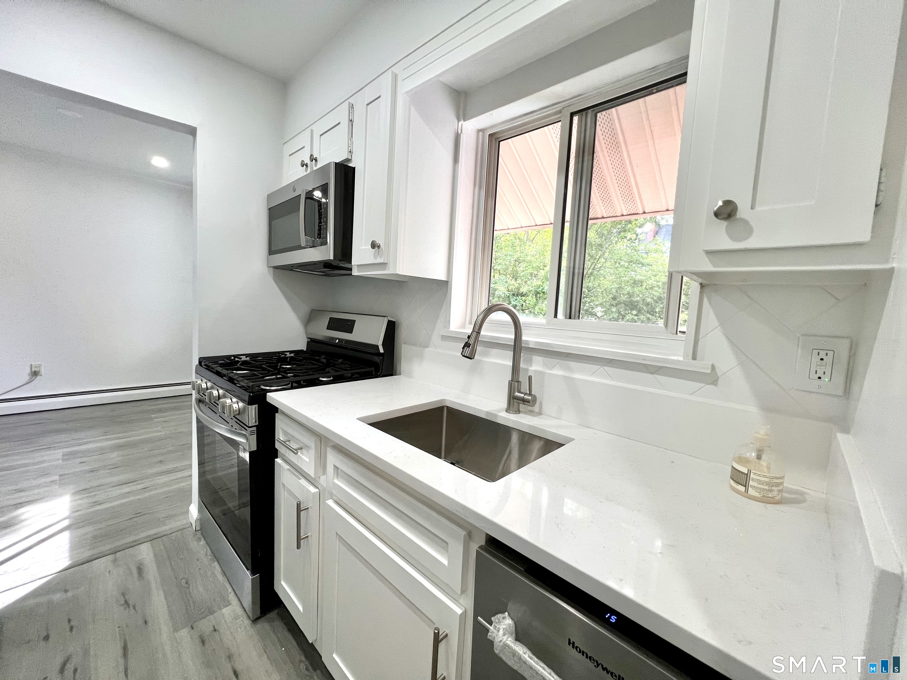 208 Flax Hill Road, Unit 32 Norwalk, CT 06854 - Photo 2 of 12 a kitchen with a sink and cabinets