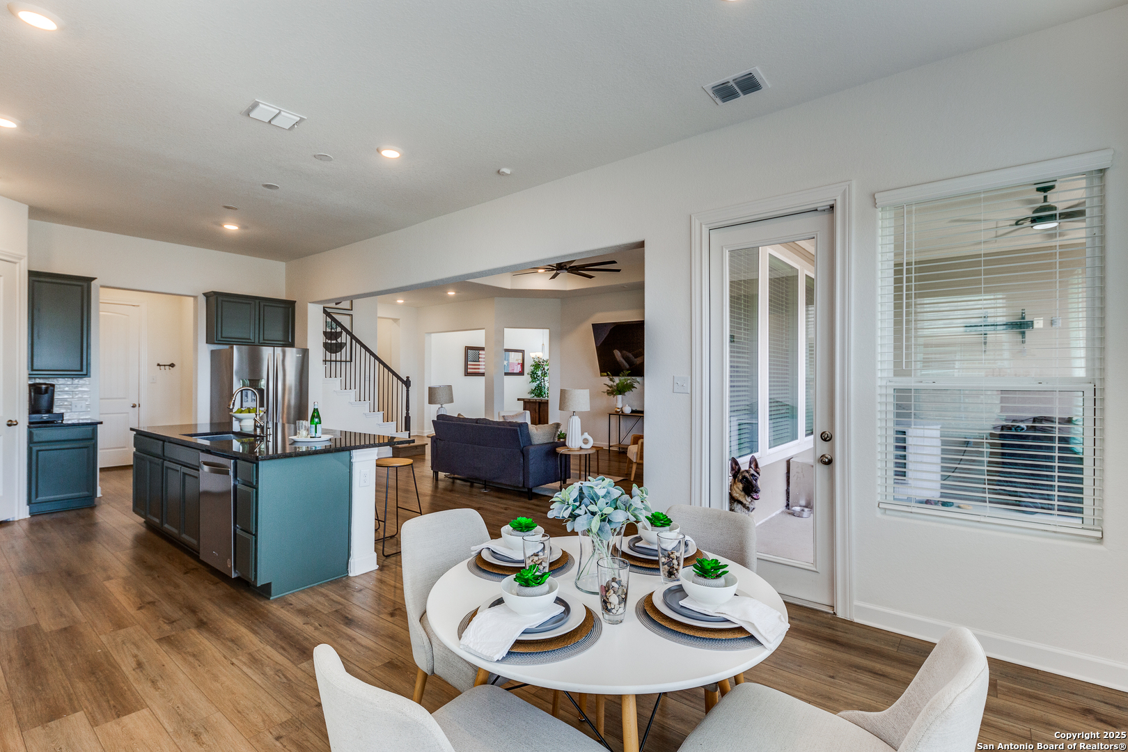 390 Rhapsody View Spring Branch, TX 78070 - Photo 13 of 39 a view of a dining room with furniture a kitchen and wooden floor