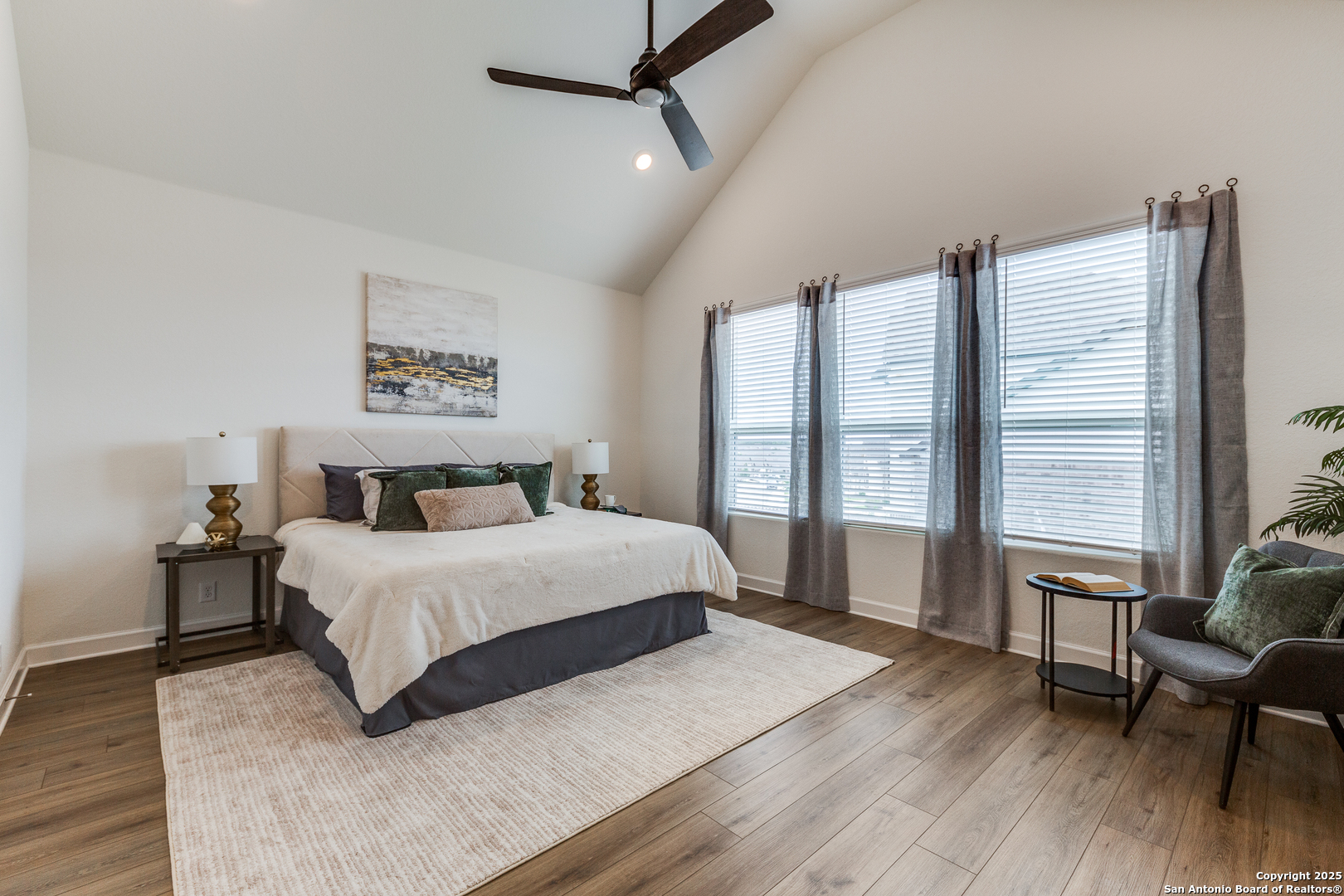 390 Rhapsody View Spring Branch, TX 78070 - Photo 16 of 39 a bedroom with a large bed wooden floor and windows