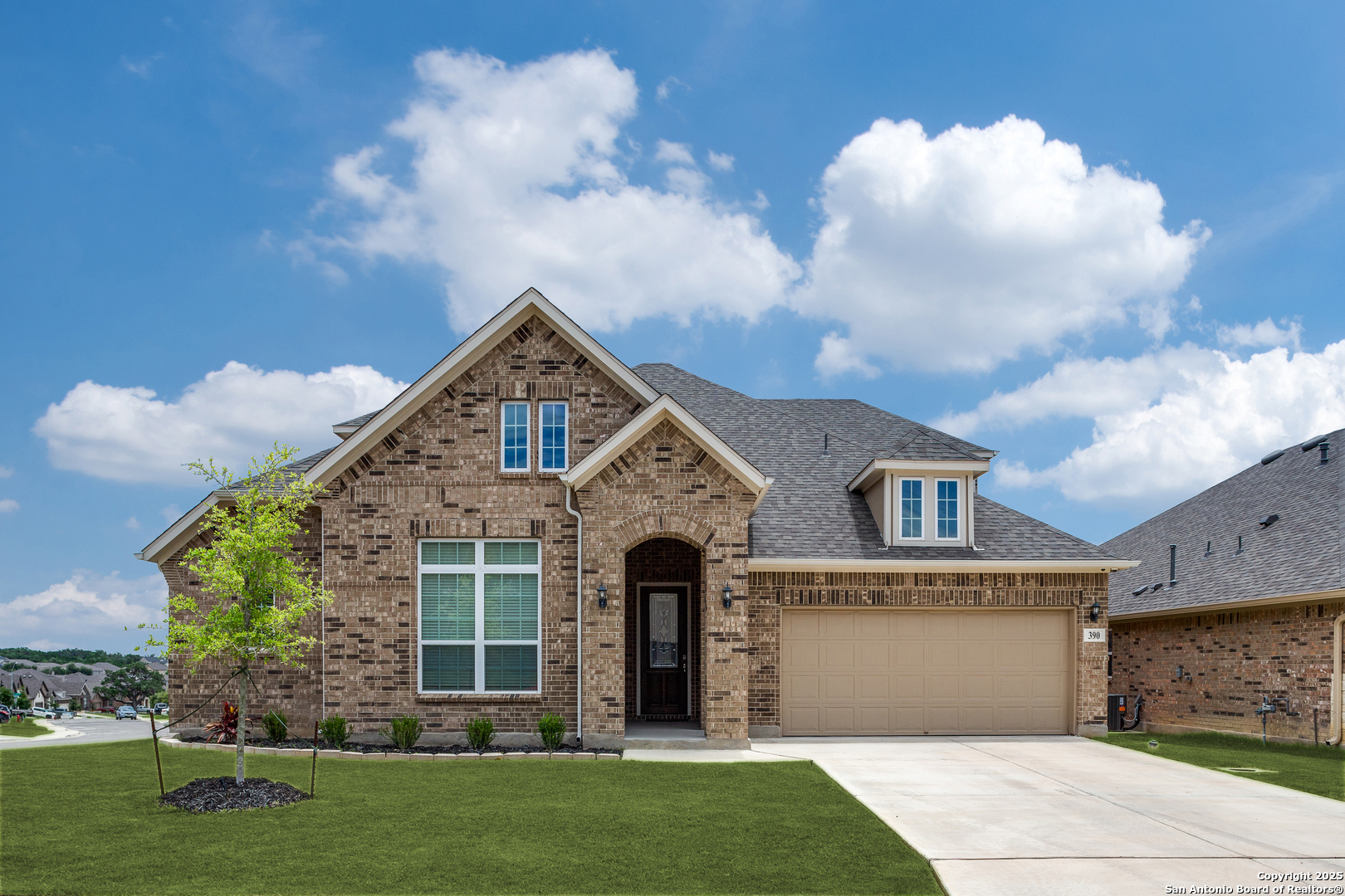 390 Rhapsody View Spring Branch, TX 78070 - Photo 2 of 39 a front view of a house with a garden and yard